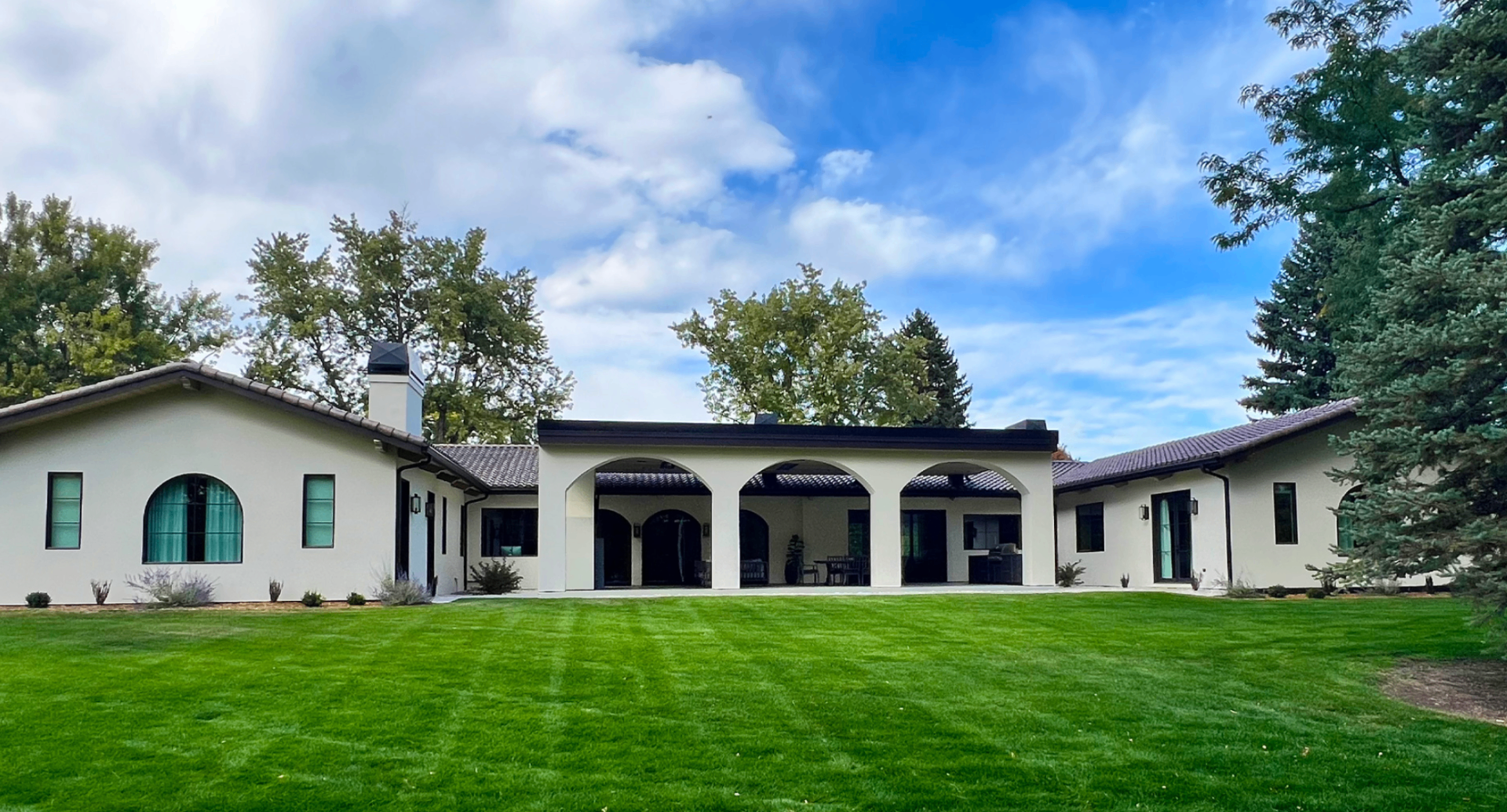 Arched-colonnade residence with manicured lawn