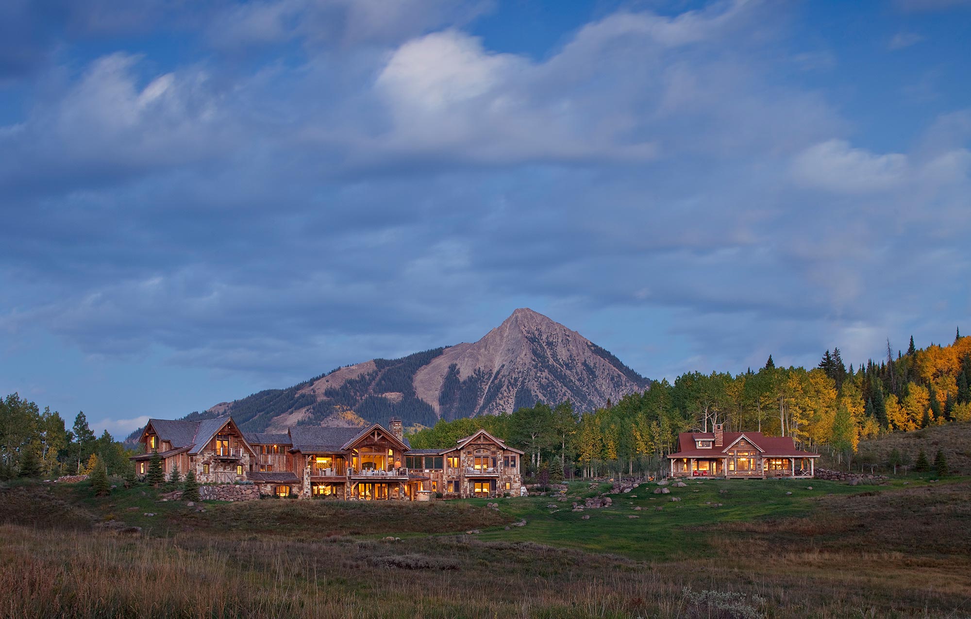 Crested Butte estate at dusk with the mountain rising behind it