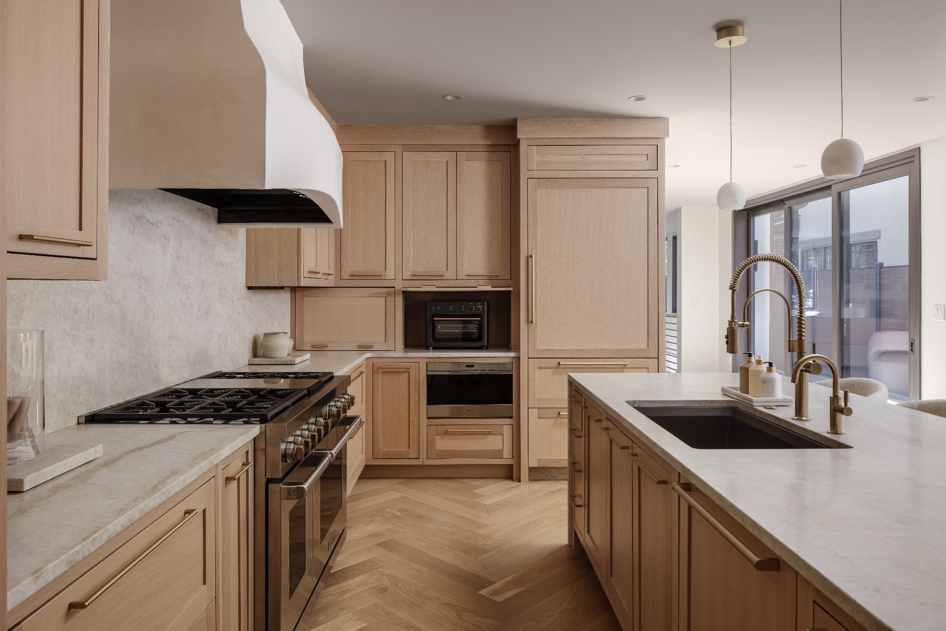 Cherry Creek kitchen range wall with white oak cabinetry and plaster hood