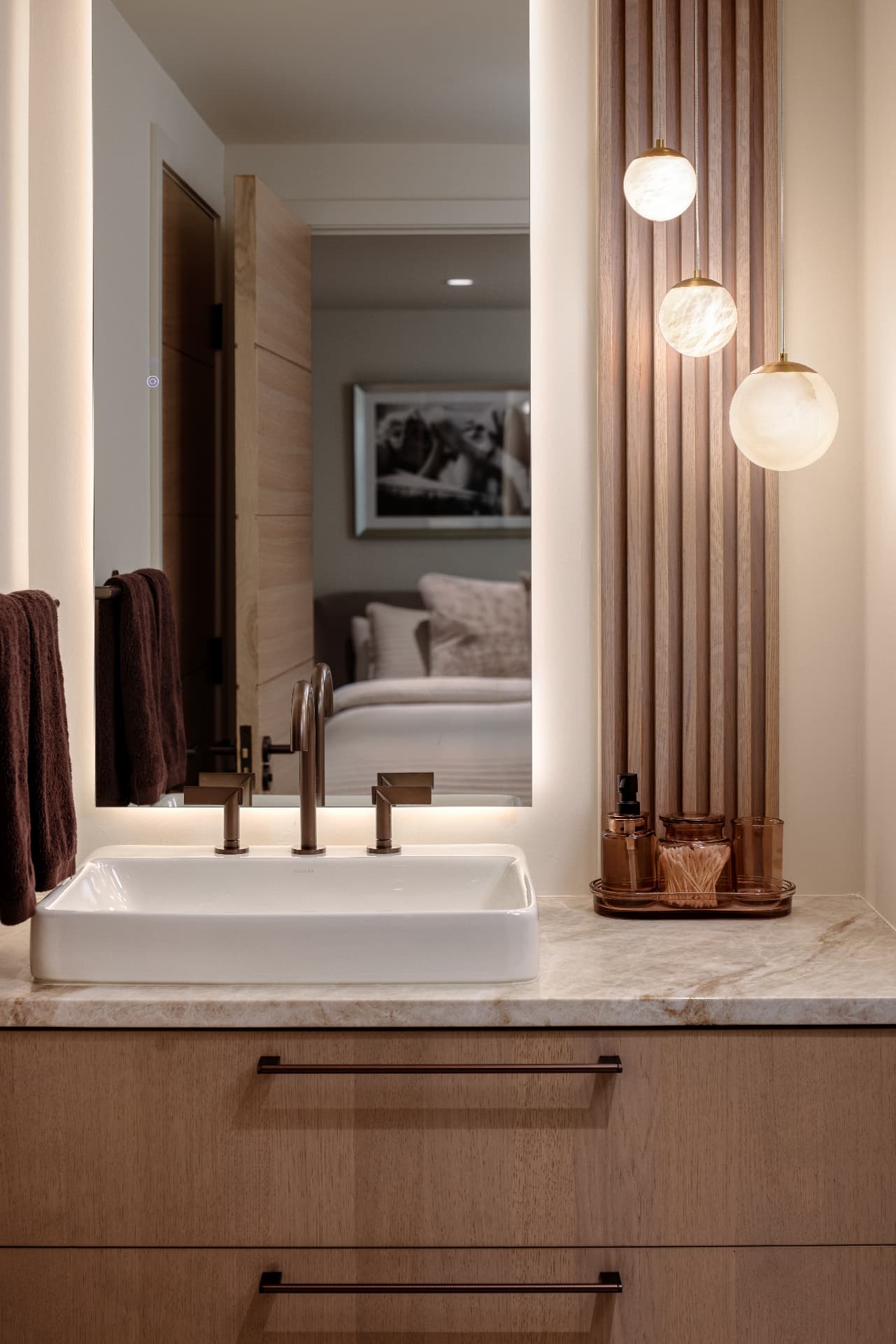 Cherry Creek bath vanity with alabaster globe pendants and fluted oak panel