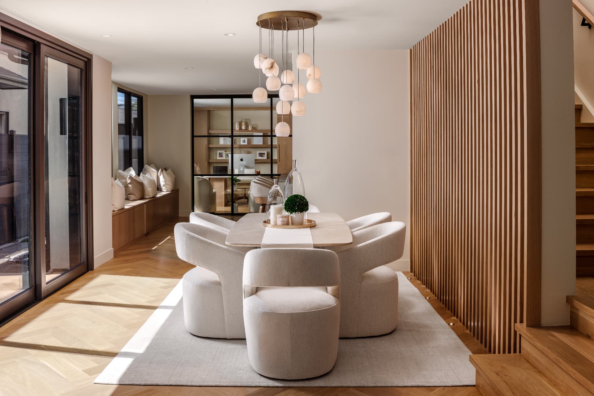 Cherry Creek dining room with alabaster globe chandelier and white oak slat wall