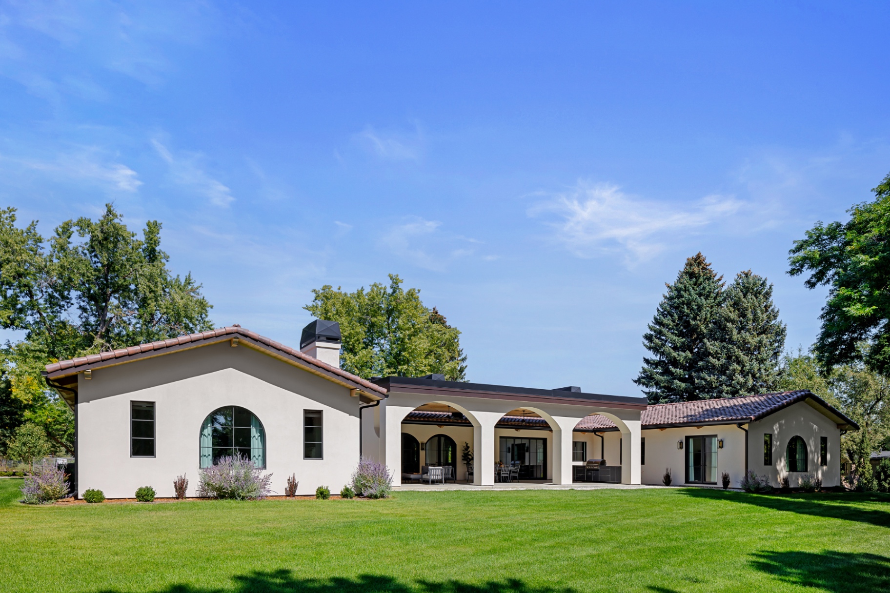 Daytime rear elevation with tile roof and arched windows