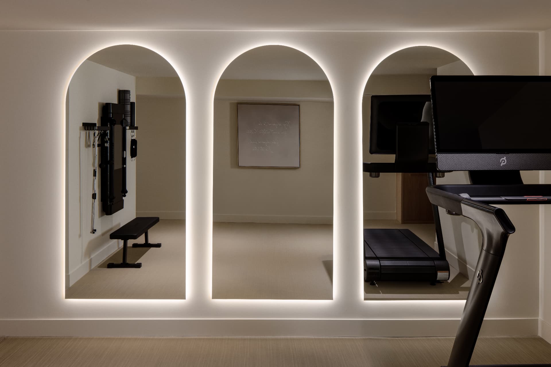 Cherry Creek home gym with three arched backlit mirrors and a treadmill