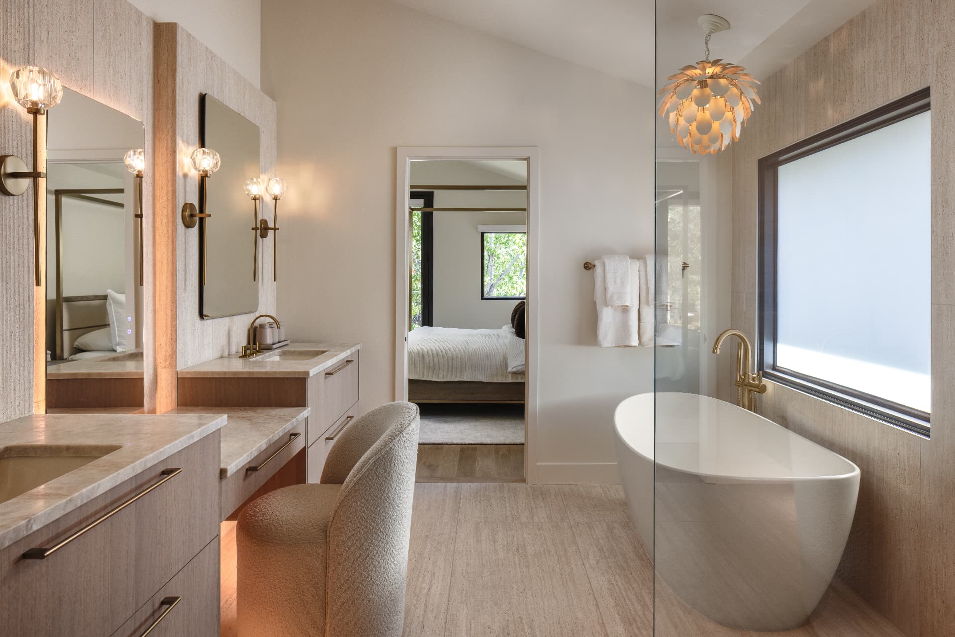 Cherry Creek primary bath with double vanity, freestanding tub, and sculptural chandelier