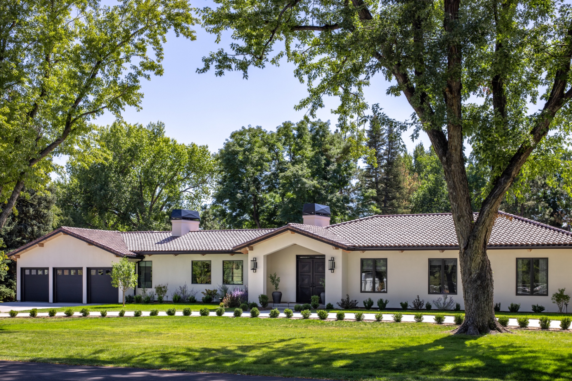 Bow Mar modern villa exterior with tile roof and landscaped lawn