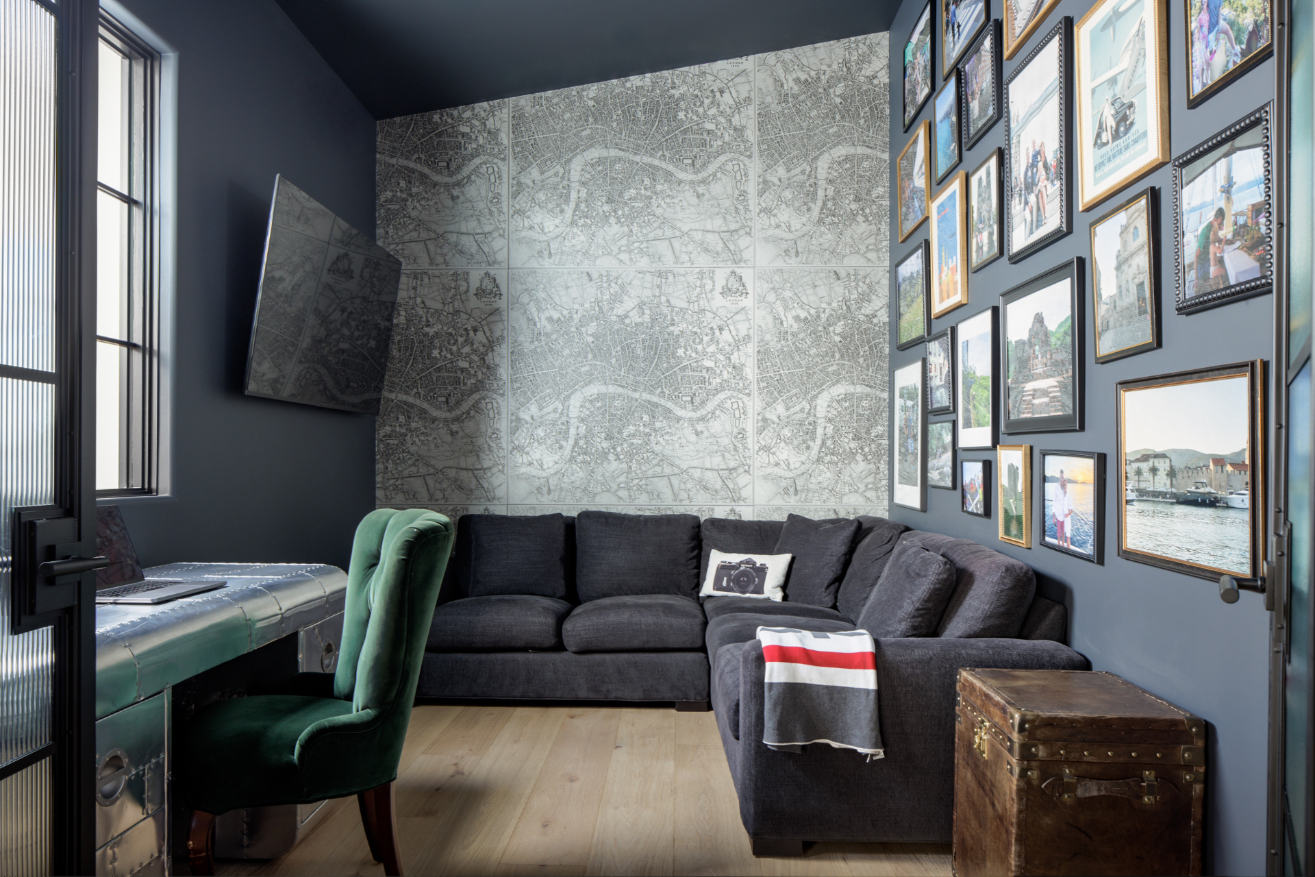 Navy study with map wallpaper, gallery wall, and a metal desk