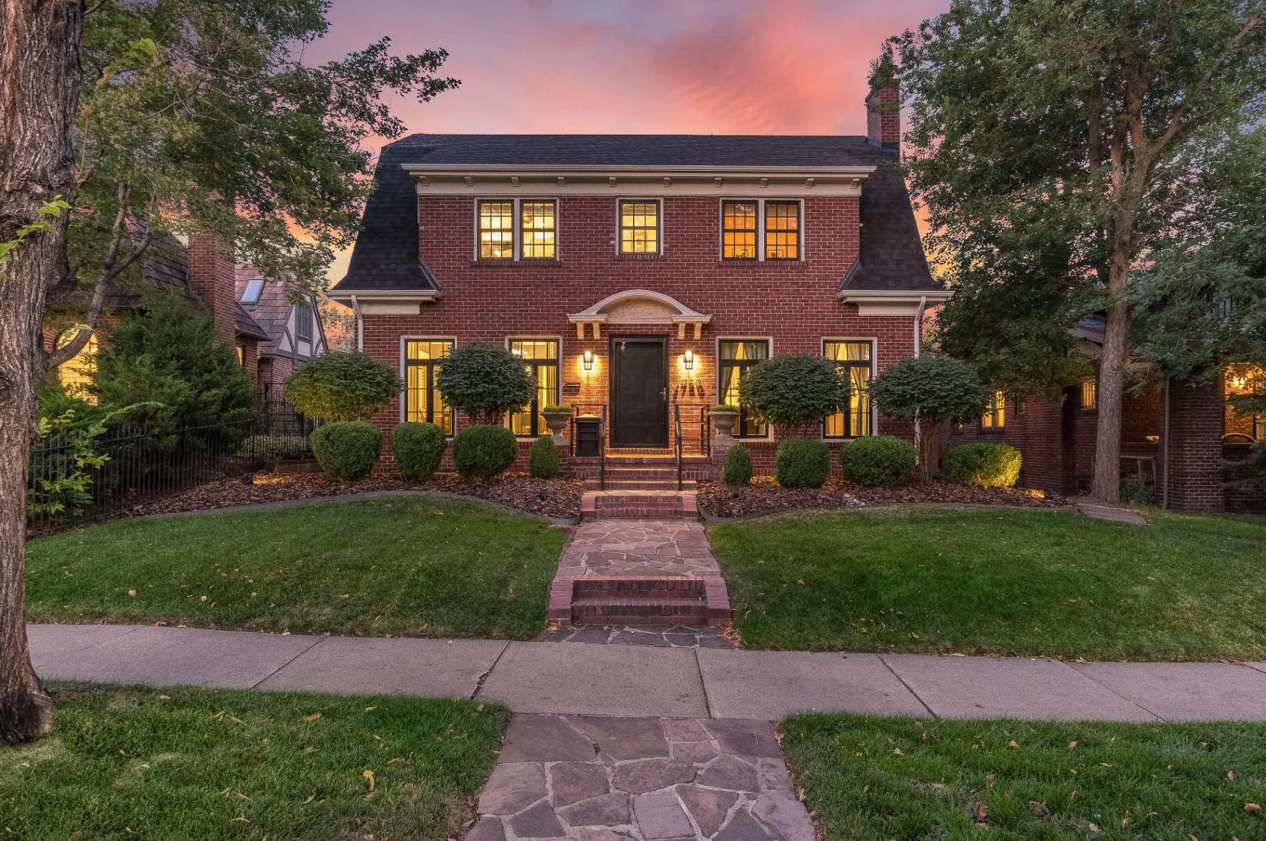 Brick front elevation of the Congress Park residence at twilight