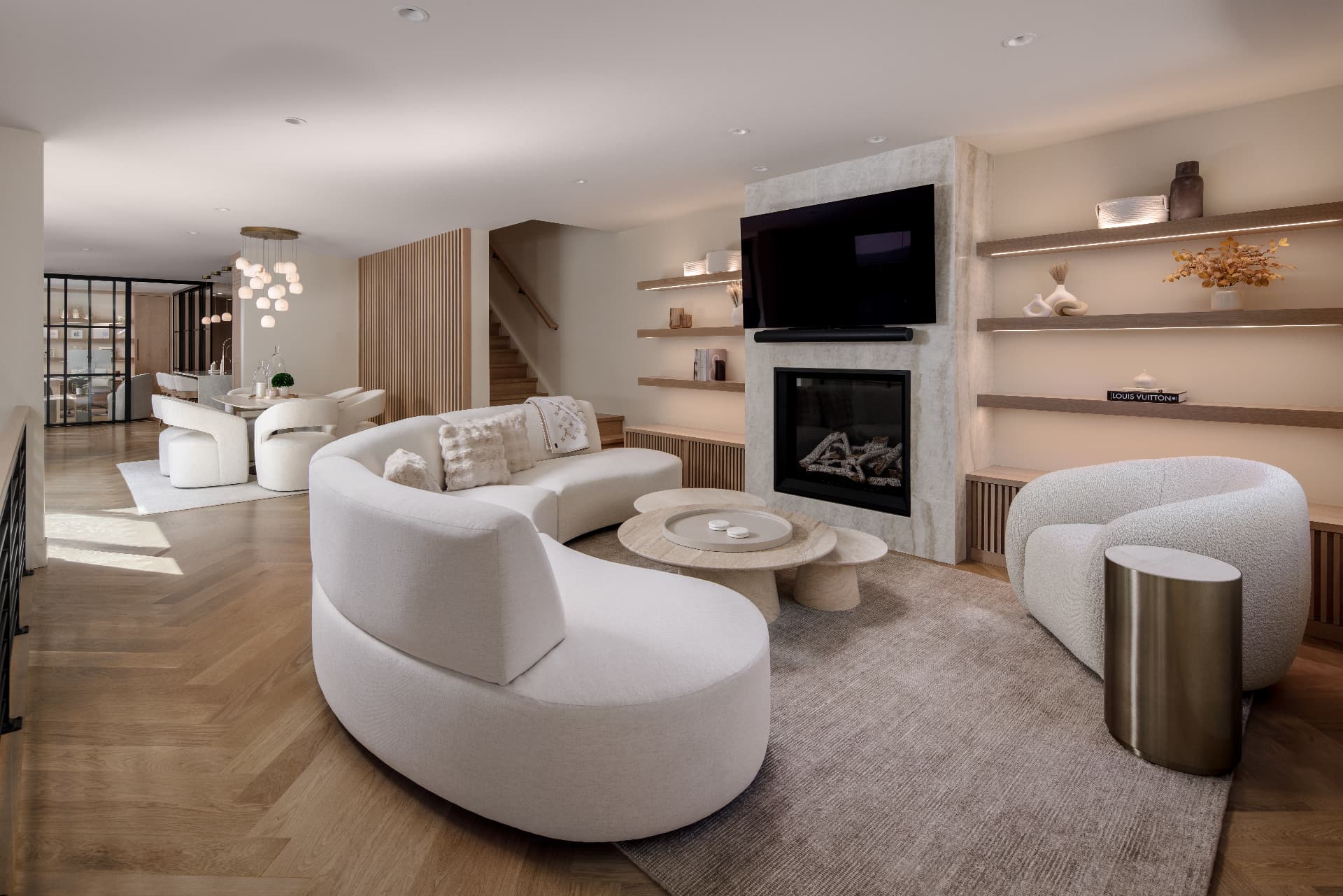 Cherry Creek living room with curved bouclé sectional and marble fireplace