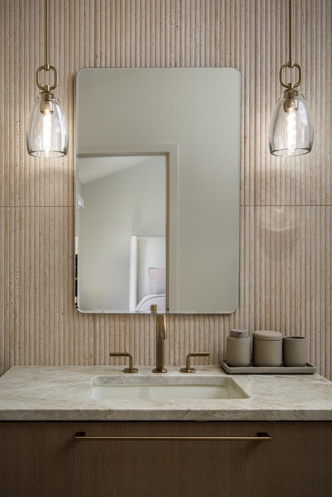 Cherry Creek guest bath vanity detail with brass pendants and marble counter