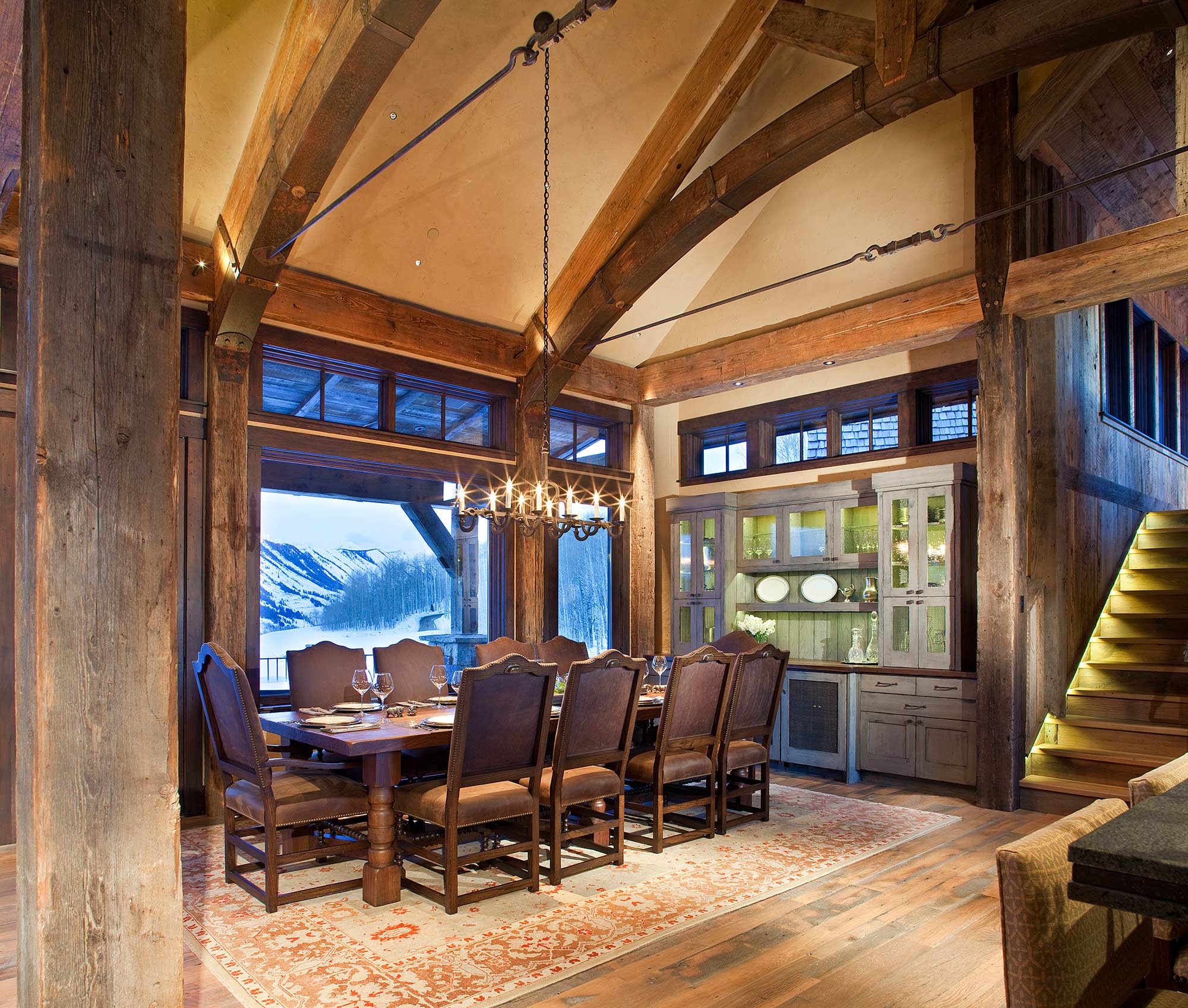 Dining room beneath vaulted timber arches with mountain views