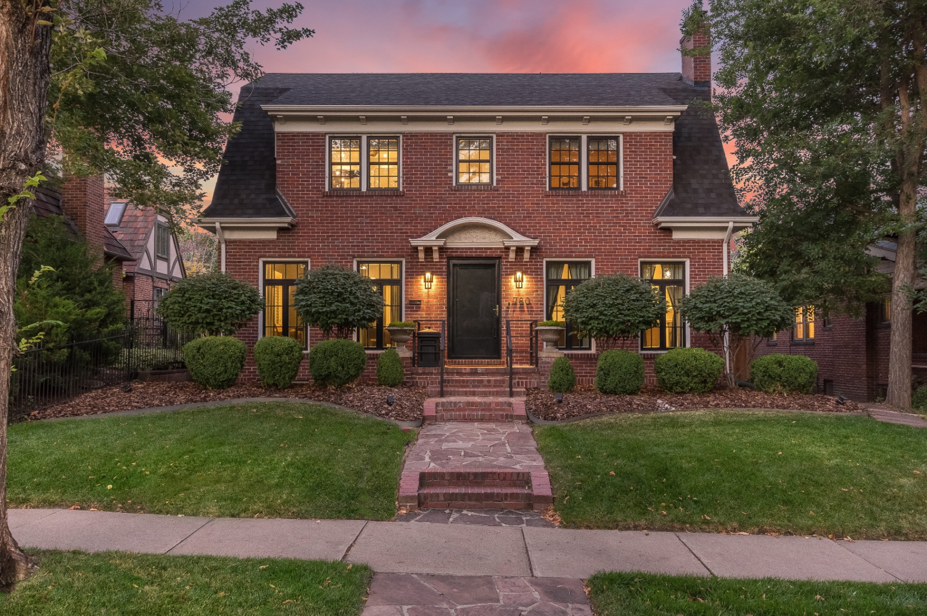Brick front elevation of the Congress Park residence at twilight